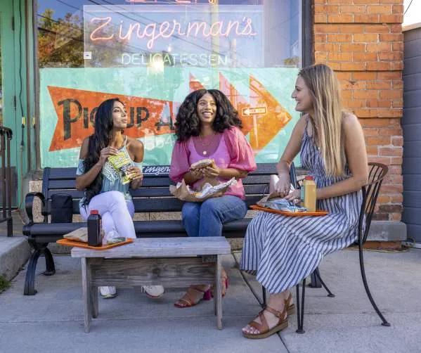 Three women eating out in front of Zingerman