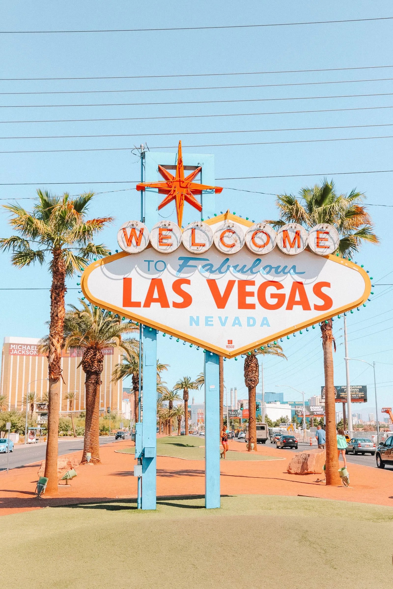 Tourists posing for photos in front of the classic &quot;Welcome to Fabulous Las Vegas&quot; sign