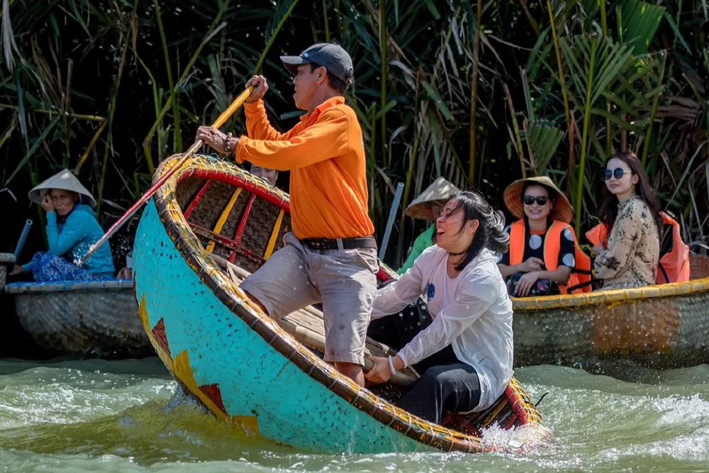Travelers enjoy a fun basket boat dance experience in Vietnam's Coconut Forest near Hoi An