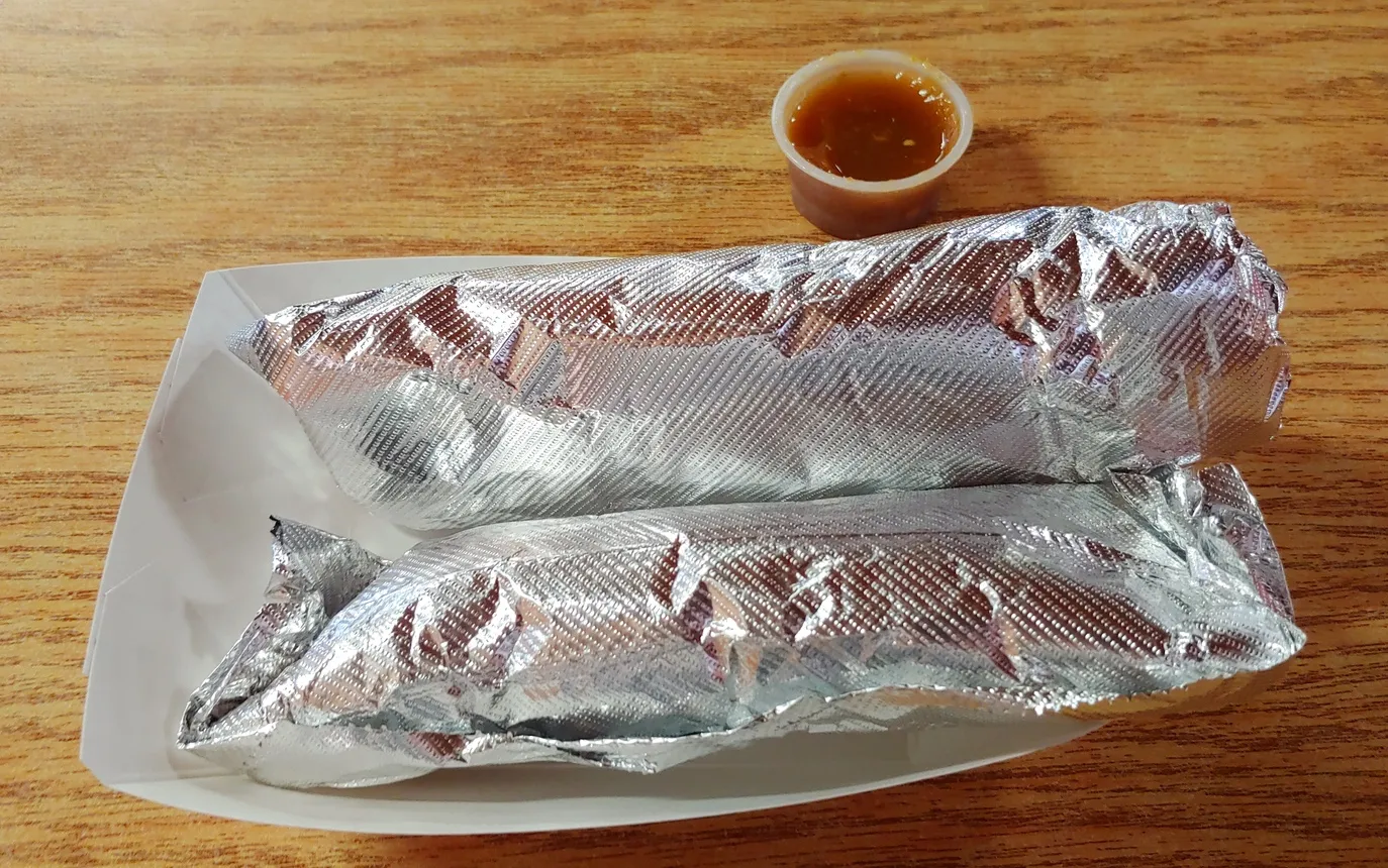 Two wrapped breakfast tacos on a plate