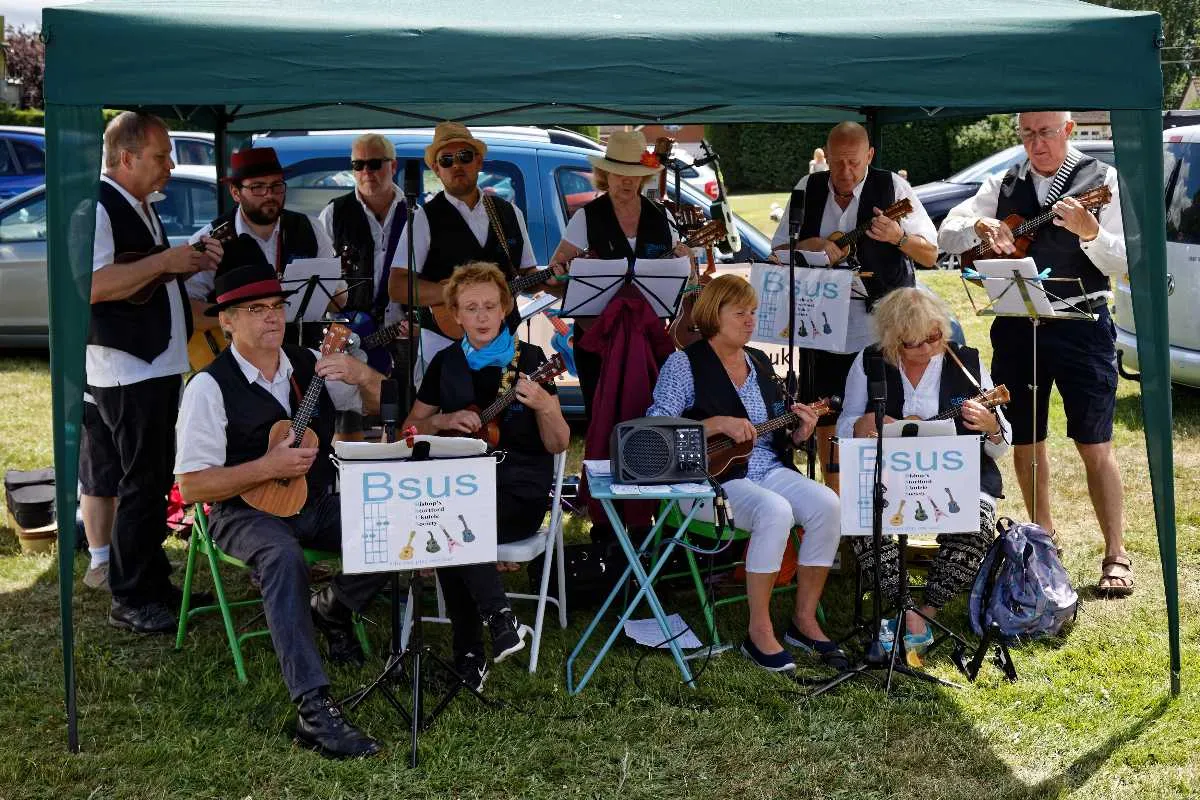 Ukulele band performing outdoors in a park