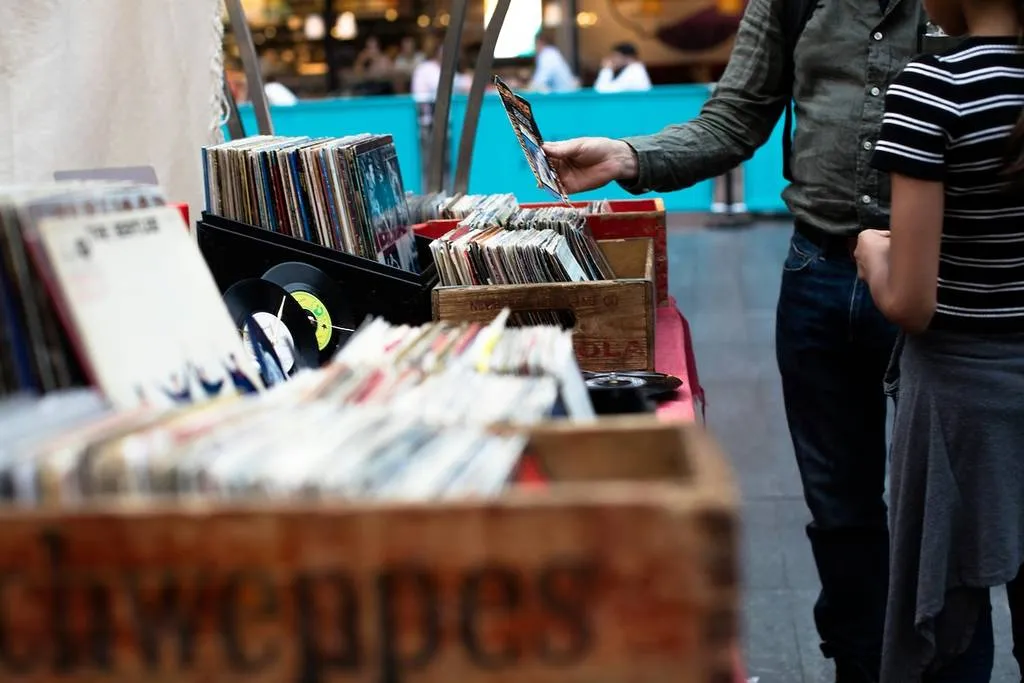 Unidentified people perusing records at a flea market