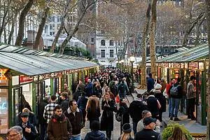 Vendors and shoppers browse at the Bank of America Winter Village holiday shops in Bryant Park, a festive answer to what to do in NYC in December.