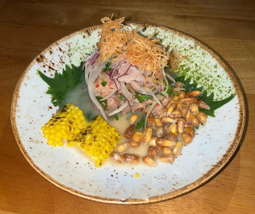 Vibrant Nikkei Ceviche with torched salmon, citrus, shiso, and cancha
