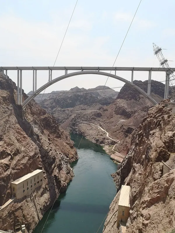 View from the Hoover Dam looking down towards the Colorado River below, showcasing the scale of the structure