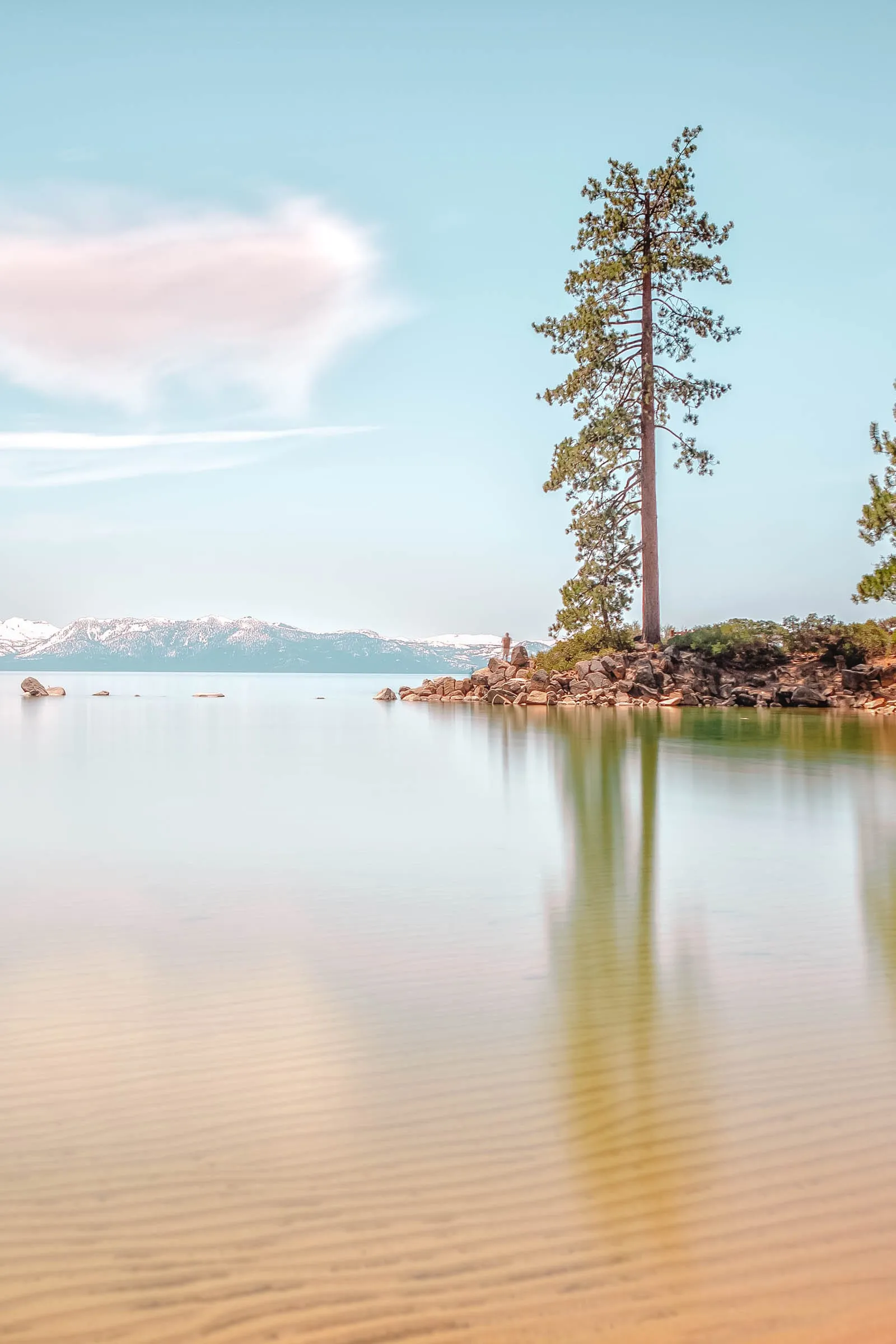 View of Lake Tahoe shoreline with clear water and rocks