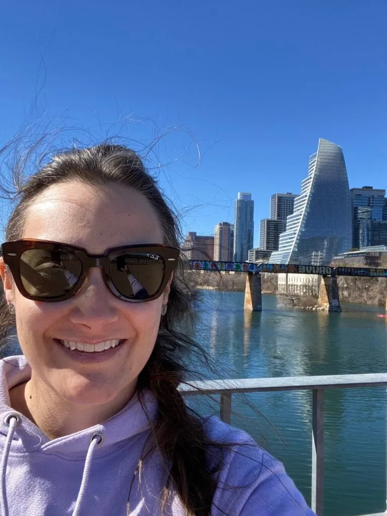 View of the Austin skyline from the trail around Lady Bird Lake, a popular spot for solo walks and activities.