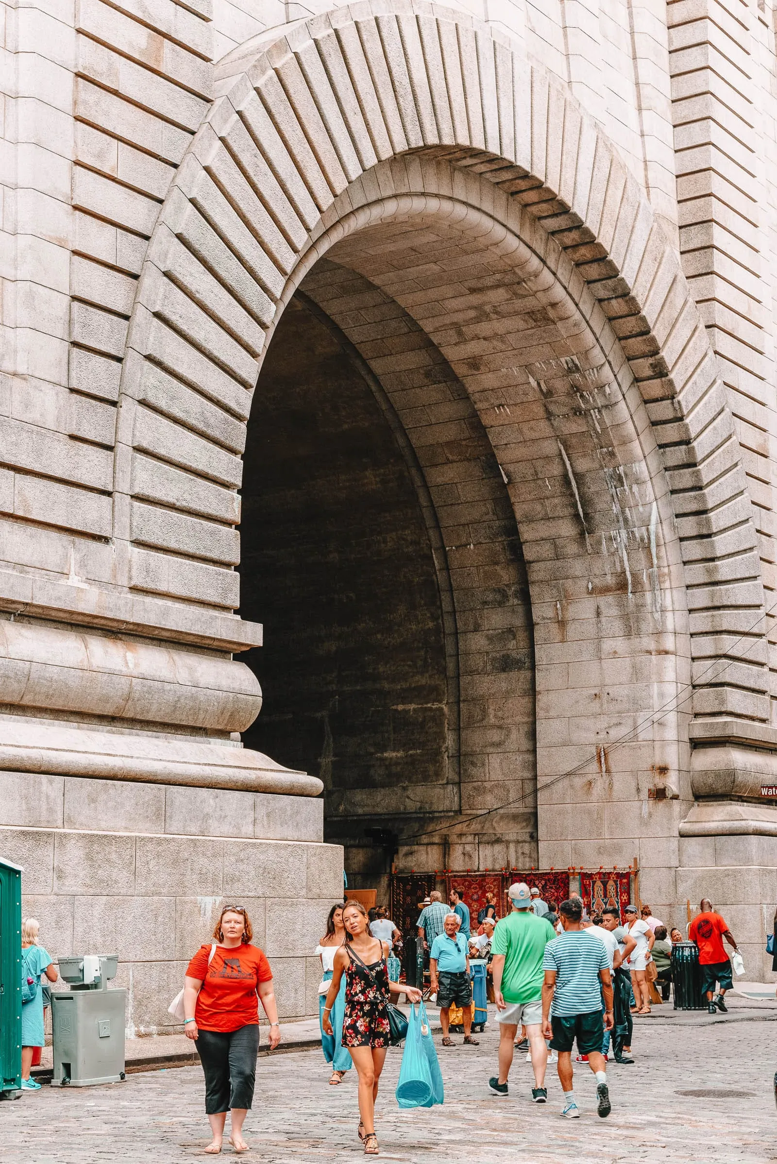 View of the Manhattan Bridge framed by buildings in Dumbo, a classic spot for what to do in brooklyn photography