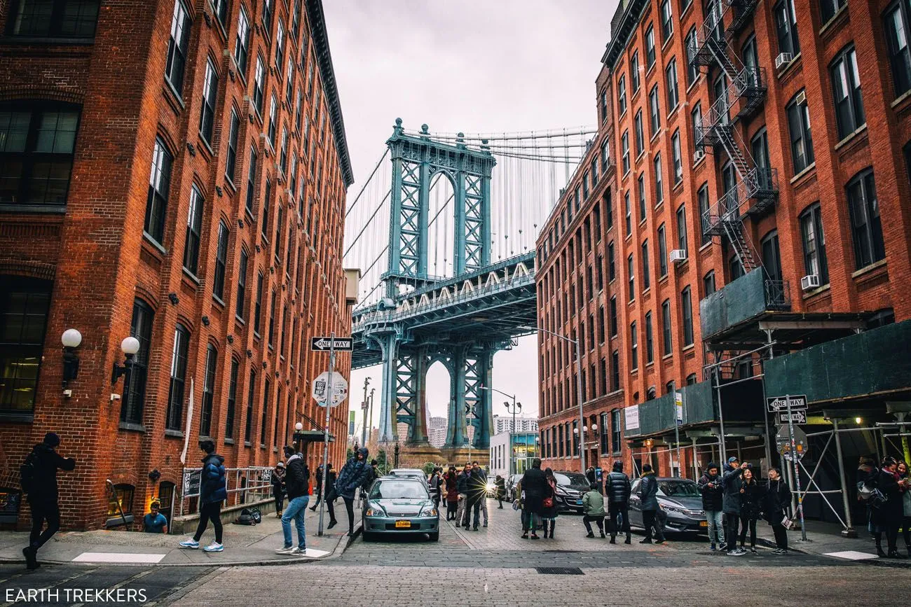 View of the Manhattan Bridge framed by buildings in Dumbo, Brooklyn