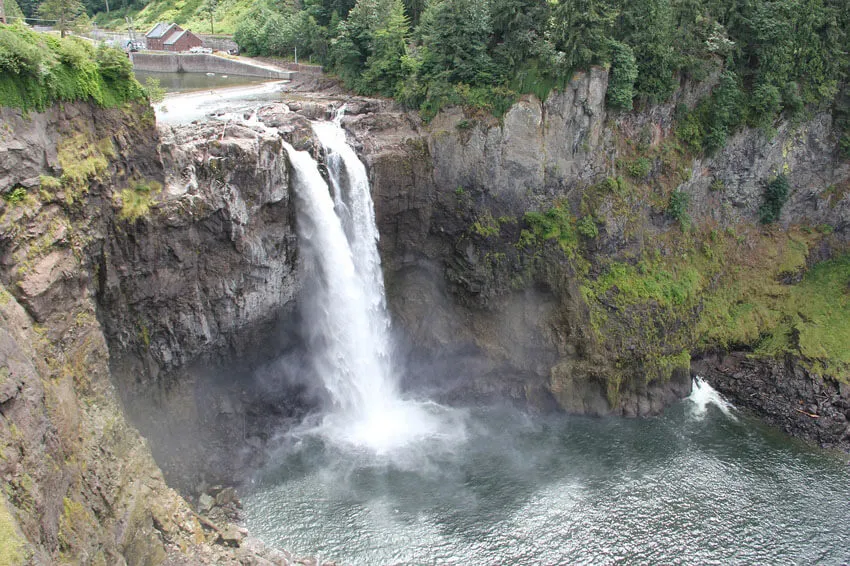 View of the powerful Snoqualmie Falls cascading down, surrounded by trees
