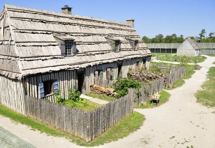 View of the reconstructed fort walls and buildings at Colonial Michilimackinac in Mackinaw City