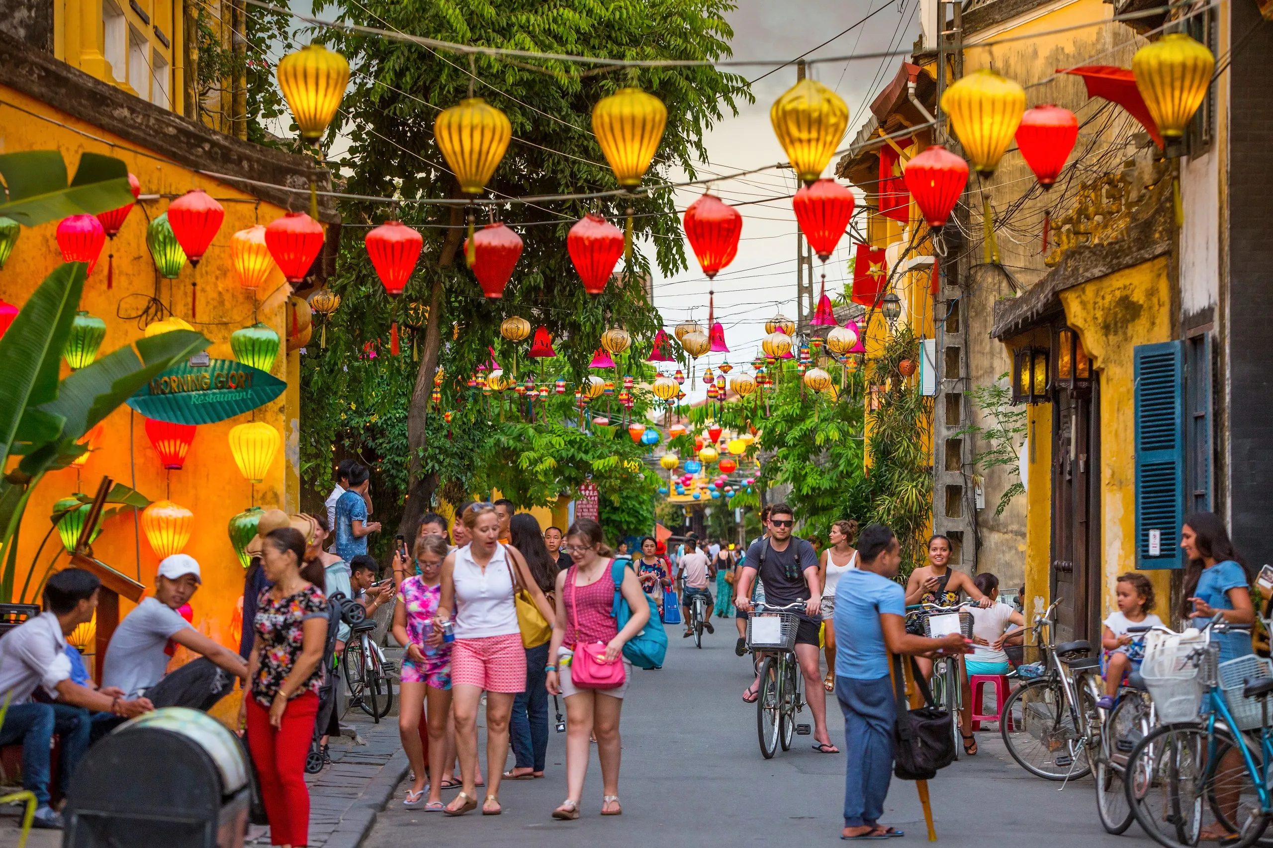 Visitors exploring the lantern-lit streets of the old town of Hoi An, a charming UNESCO World Heritage site in central Vietnam.