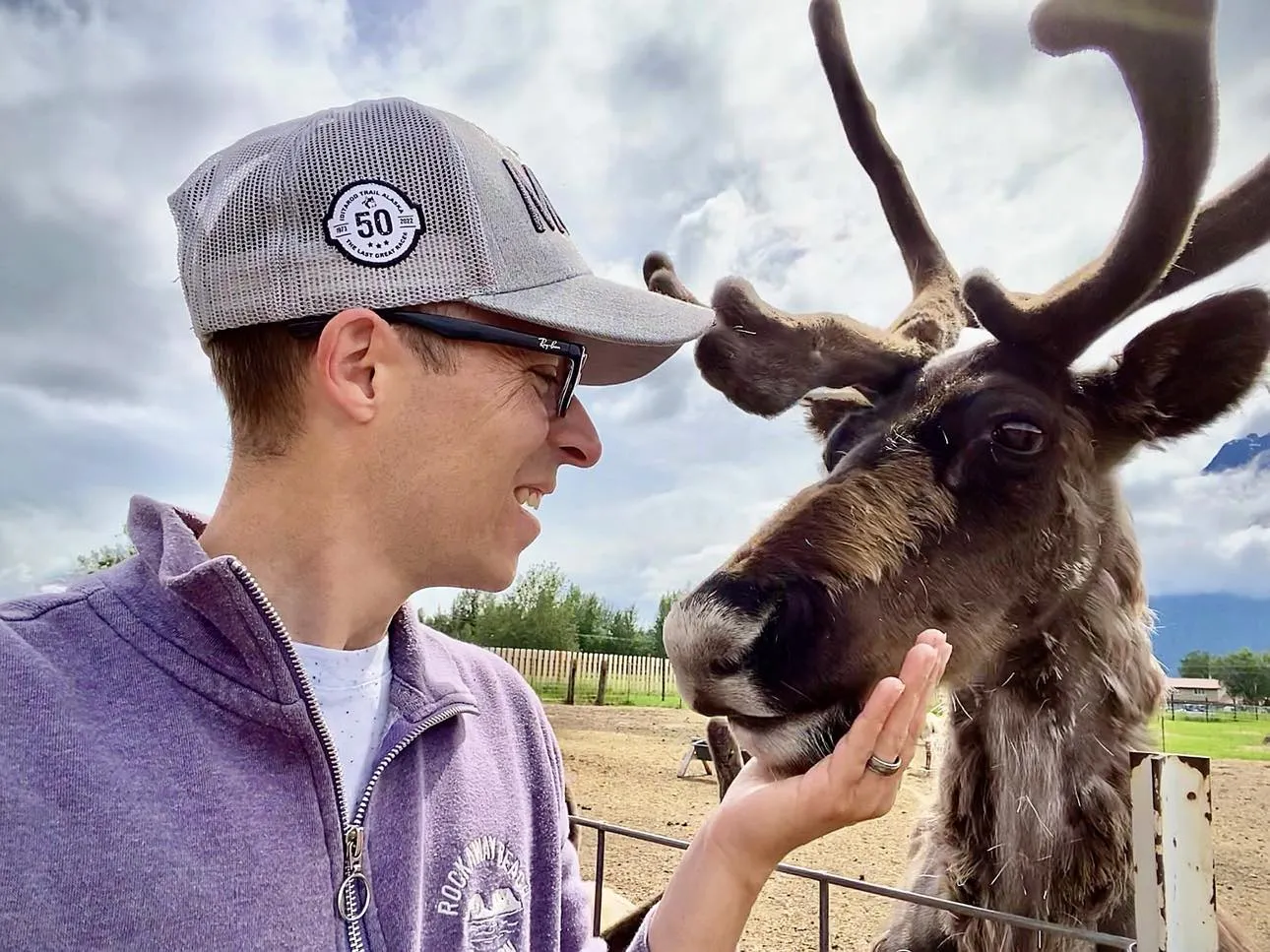 Visitors feeding reindeer at a farm in Alaska