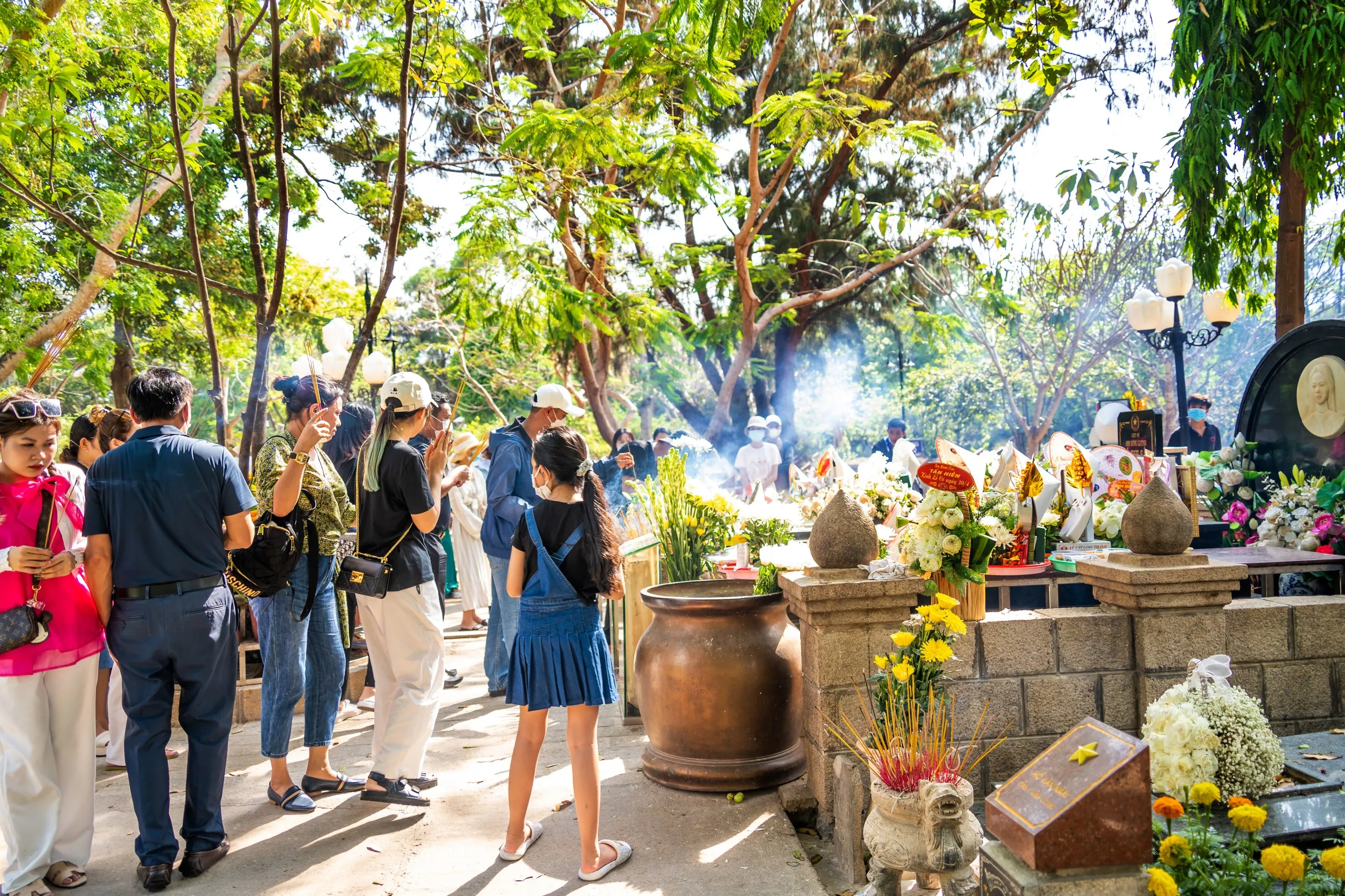 Visitors walking through the cemetery on Con Dao island, a place of reflection on the island's complex history in Vietnam.