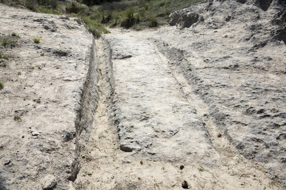 Wagon wheel ruts embedded in rock at the Oregon Trail Ruts State Historic Site