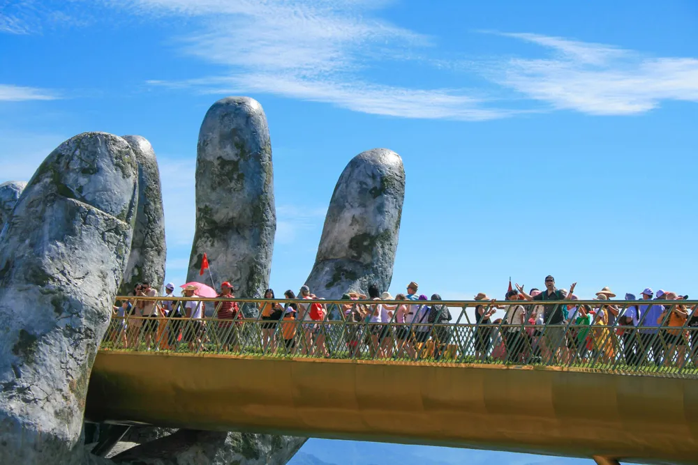 Walking across the iconic Golden Bridge held by giant hands at Ba Na Hills, Vietnam