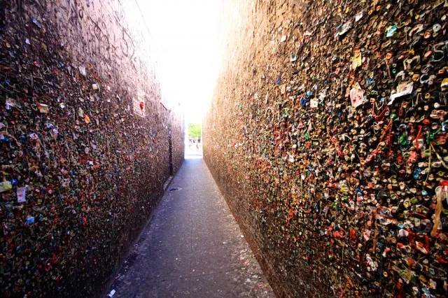 Walls of a narrow alley covered in colorful chewed bubblegum