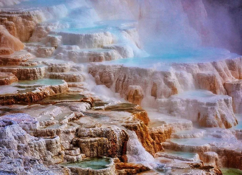 Water flowing down terraced limestone formations at Mammoth Hot Springs, Yellowstone - Geothermal Things To See And Do In Wyoming