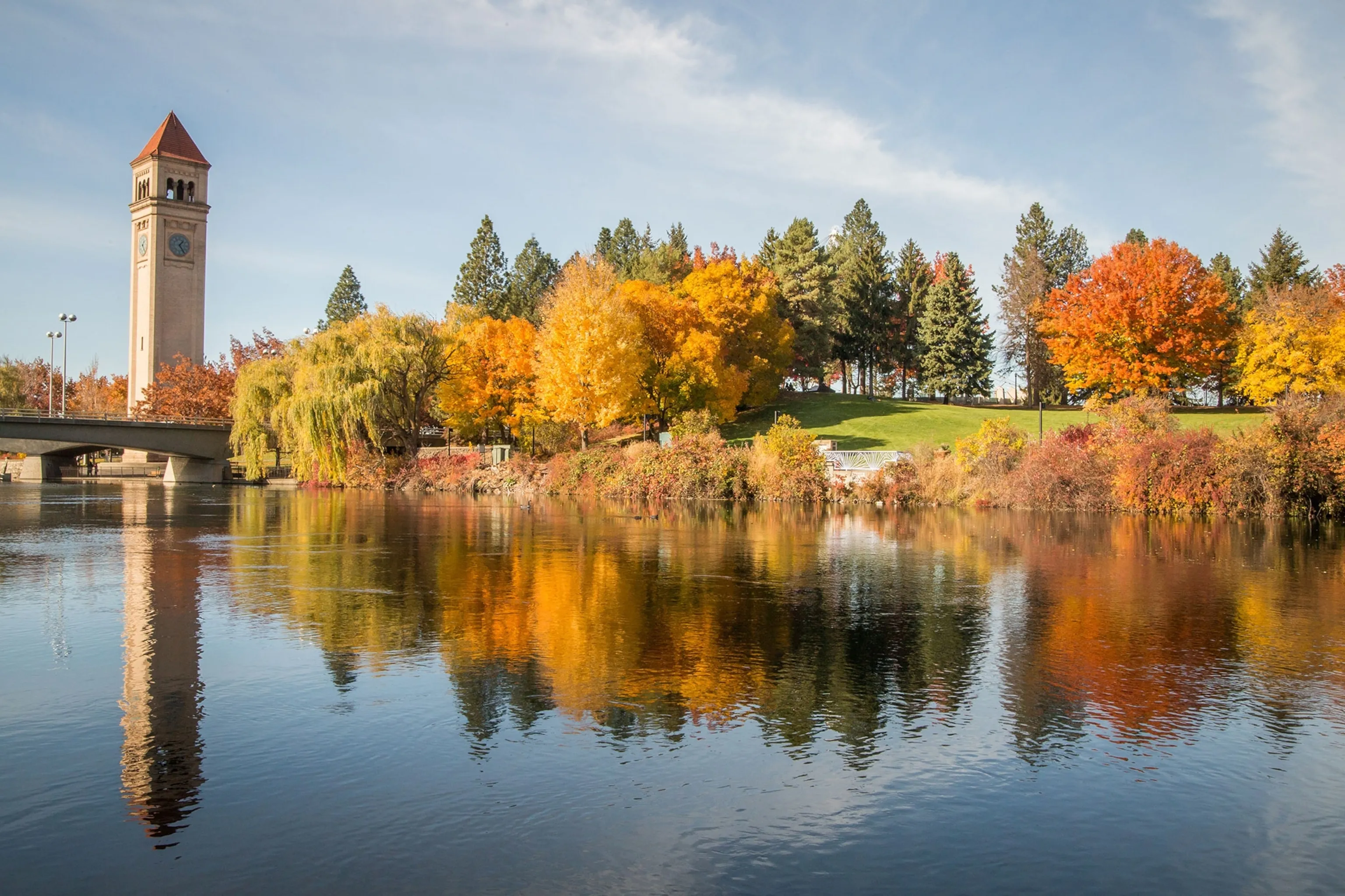 Water reflecting autumn trees in a park.