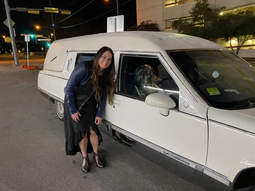 White hearse used for a haunted tour in Austin, featuring a spooky skeleton inside.