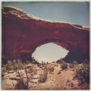Windows Arch seen from the trail in Arches National Park, Utah, on a girl from road trip adventure
